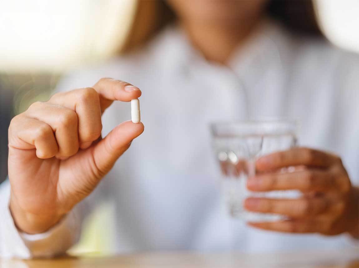 a woman with a capsule