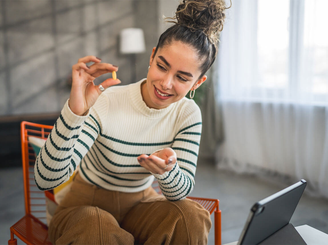woman with vitamin capsules