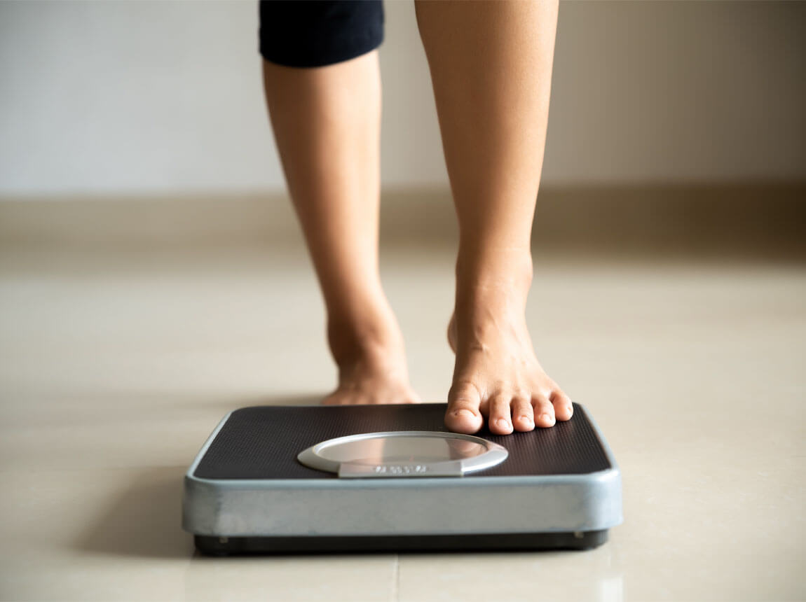 woman on scales - weight loss