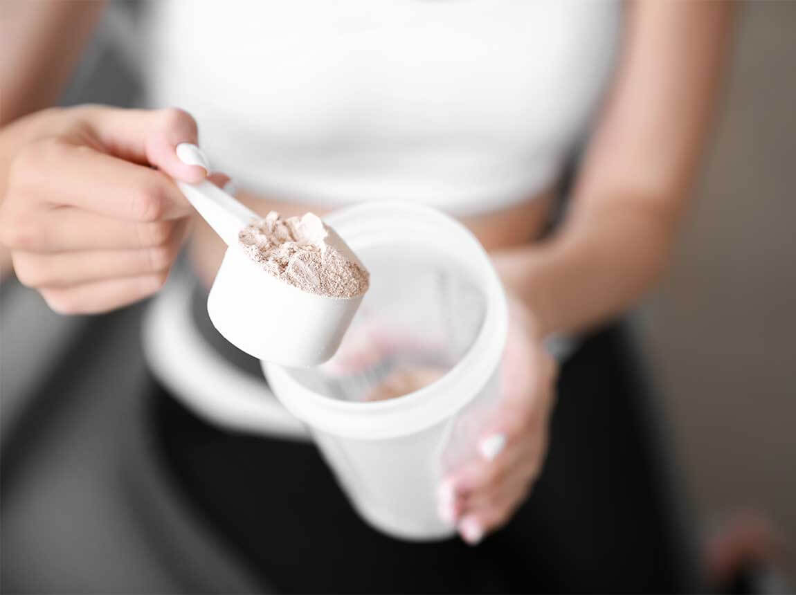 a woman with a protein shake