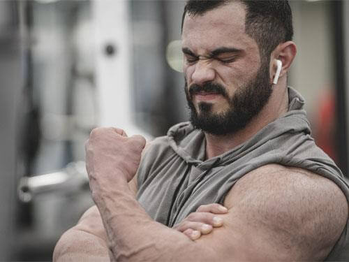 What is muscle soreness, and how long does it take to appear?