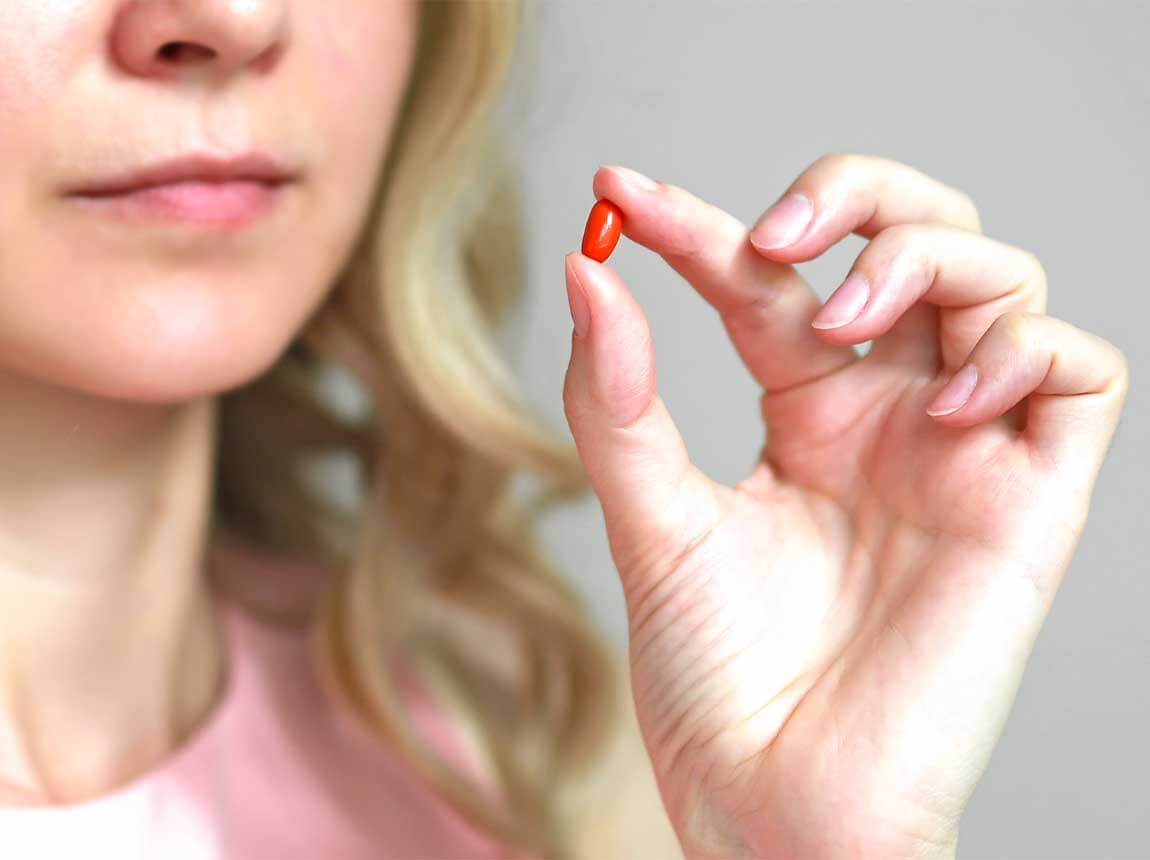 a woman with a pill &ndash; Coenzyme Q10  